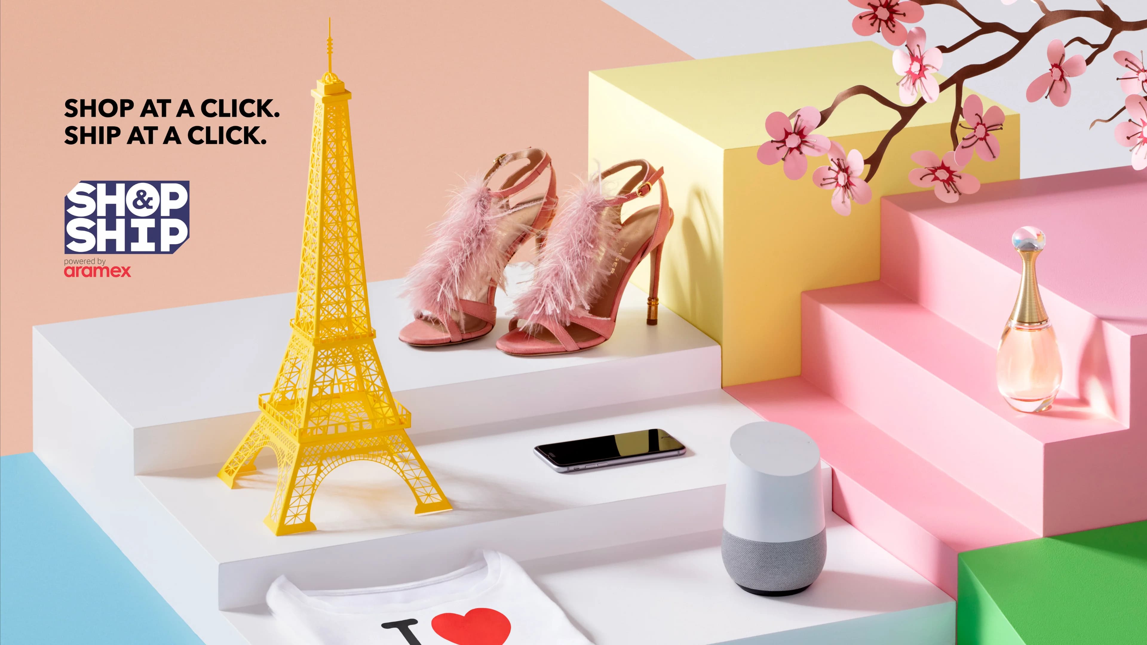 Shop & Ship paper-craft campaign visual with a gold Eiffel Tower, shoes and gifts on pastel steps